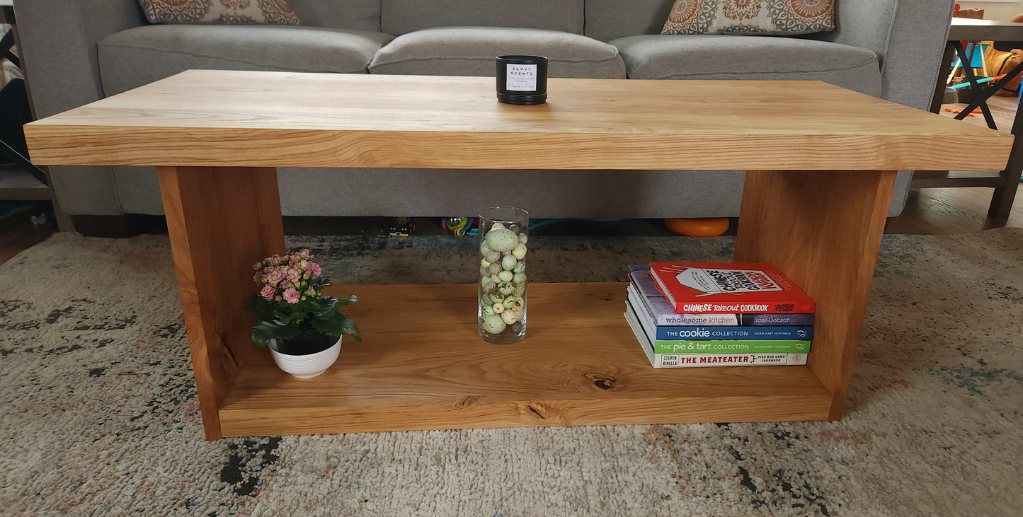 Modern cherry and ash coffee table with shelf located underneath for storage