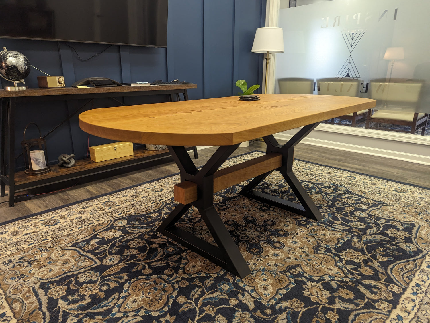 Branded cherry conference table with decorative beam in custom metal X-shaped legs