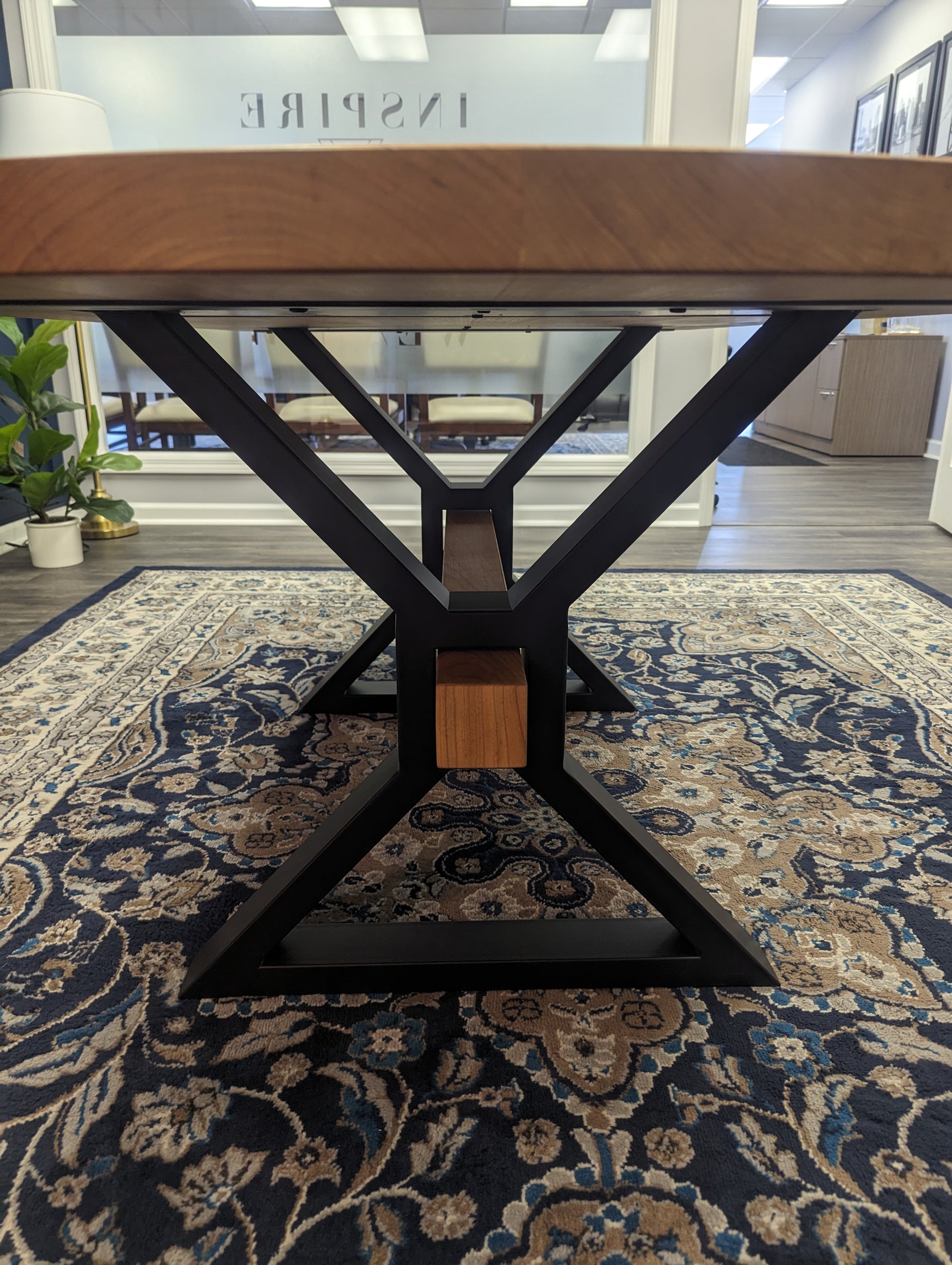 Branded cherry conference table with decorative beam in custom metal X-shaped legs