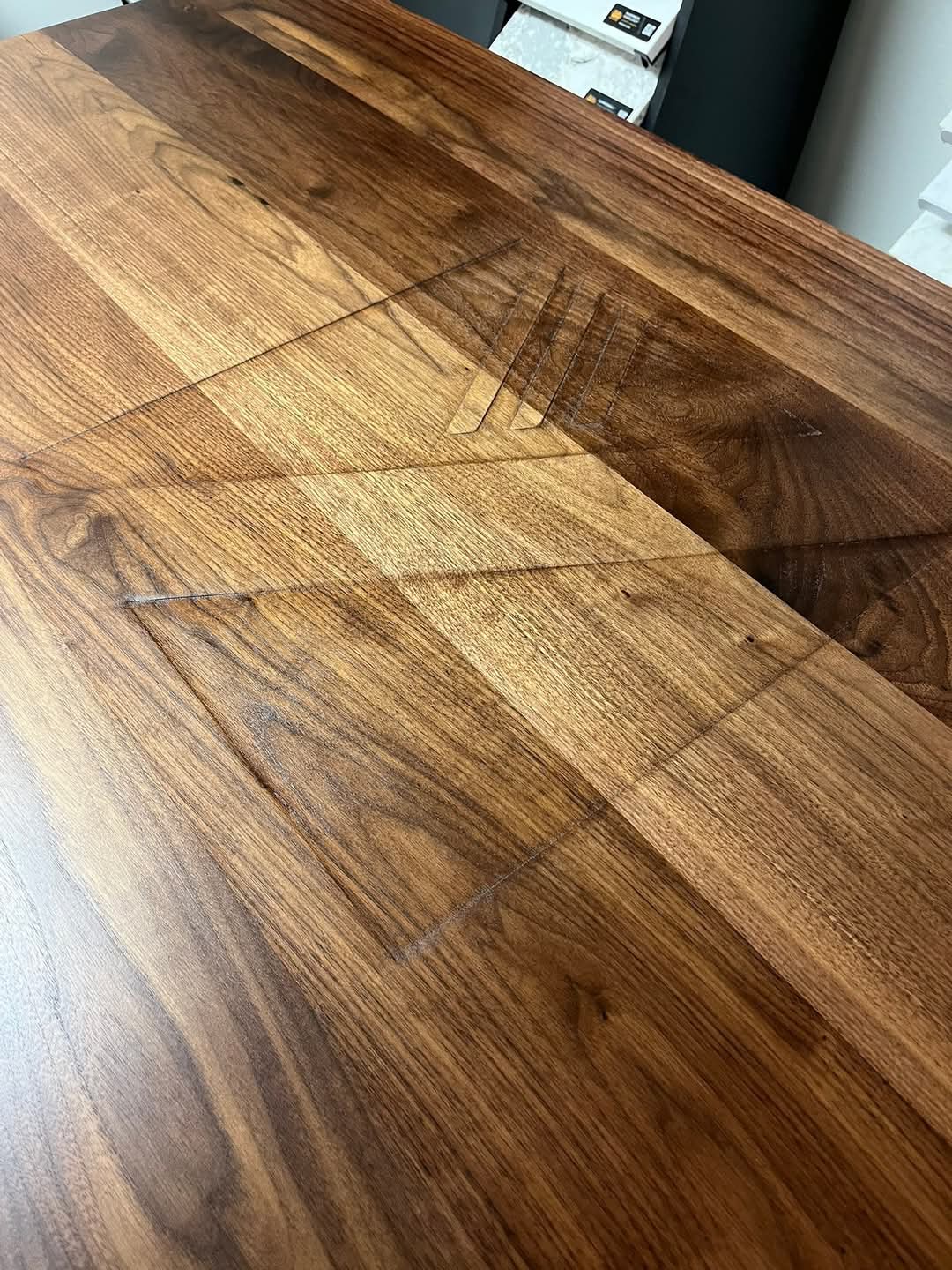 Walnut and Ash conference room table branded with interior design logo
