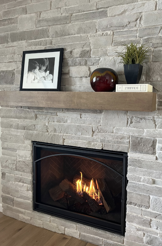 Floating maple fireplace mantel stained to complement grey stonework
