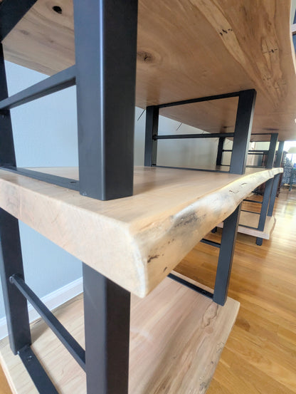 Live edge rustic ambrosia maple hardwood shelving unit with five shelves and custom fabricated black metal bars for storage of vinyl records, CDs, and corresponding players and speakers in a modern home living room.