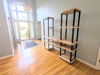 Live edge rustic ambrosia maple hardwood shelving unit with five shelves and custom fabricated black metal bars for storage of vinyl records, CDs, and corresponding players and speakers in a modern home living room.