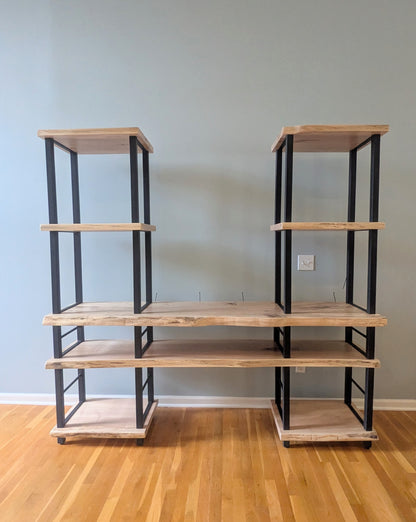 Live edge rustic ambrosia maple hardwood shelving unit with five shelves and custom fabricated black metal bars for storage of vinyl records, CDs, and corresponding players and speakers in a modern home living room.