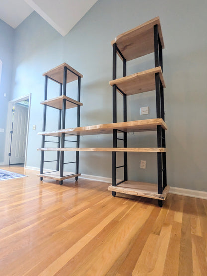 Live edge rustic ambrosia maple hardwood shelving unit with five shelves and custom fabricated black metal bars for storage of vinyl records, CDs, and corresponding players and speakers in a modern home living room.