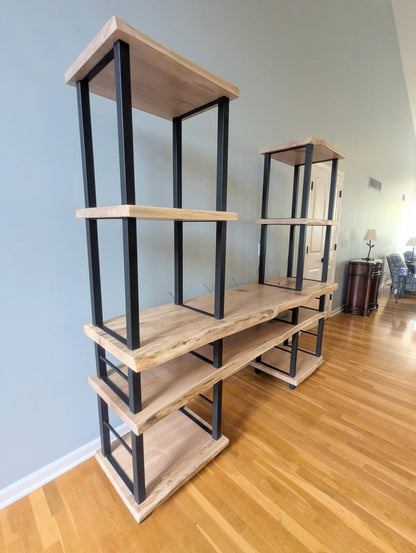 Live edge rustic ambrosia maple hardwood shelving unit with five shelves and custom fabricated black metal bars for storage of vinyl records, CDs, and corresponding players and speakers in a modern home living room.